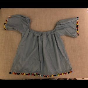Blue jean and Pom Pom off the shoulder shirt